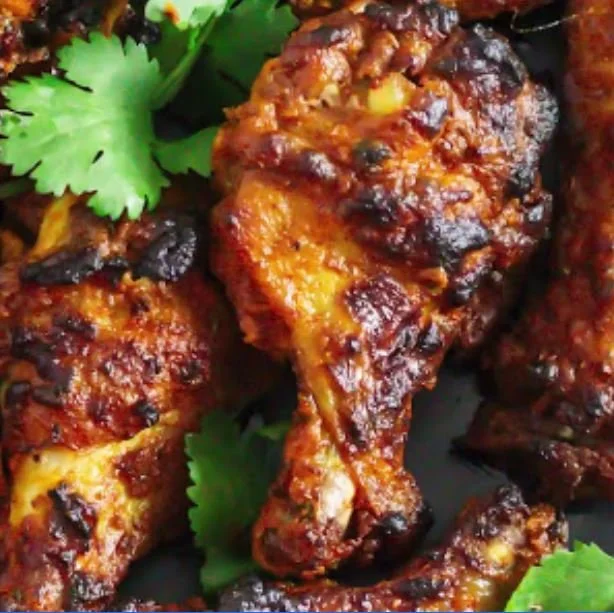 Grilled chicken drumsticks with cilantro leaves