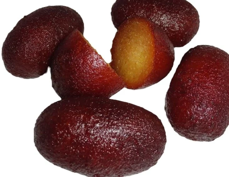 Indian dessert gulab jamun pieces on white background