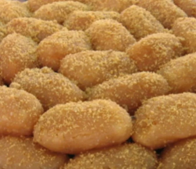 Close-up of a pile of sugar-coated Greek donuts, loukoumades.