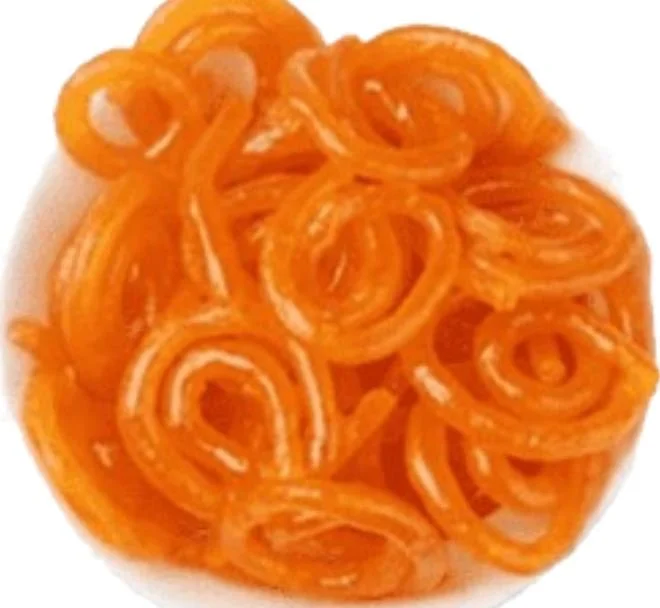 Close-up of orange jalebi, an Indian sweet made of fried dough and syrup.