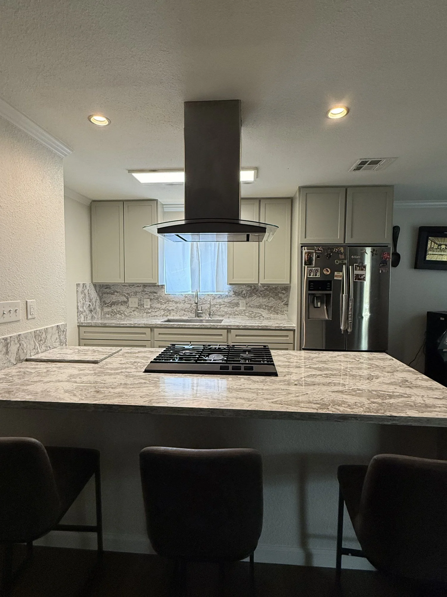 The kitchen island brings seating and cooking space together.