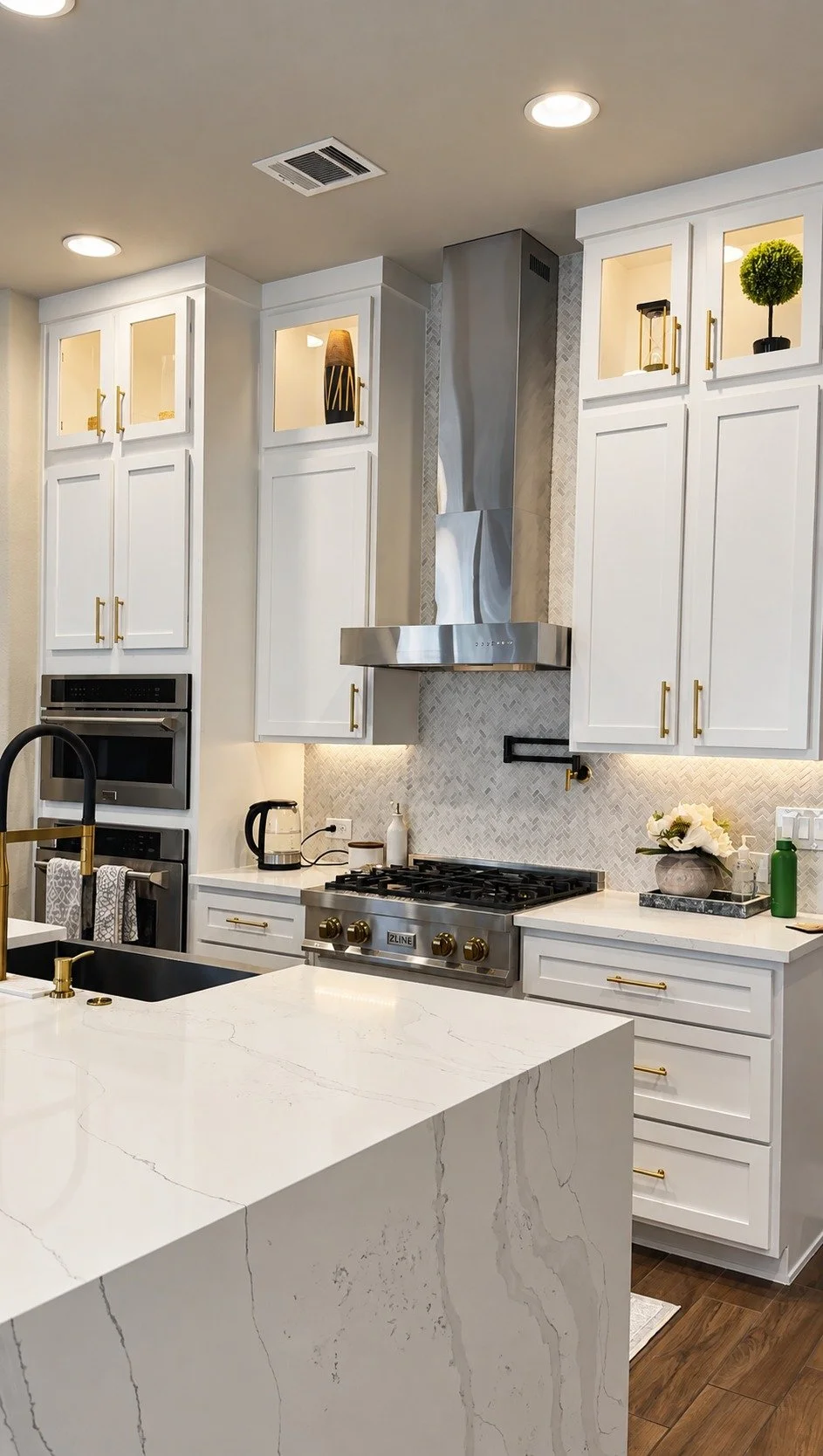 Finished Little Elm kitchen — white cabinetry, patterned backsplash, and a waterfall island.