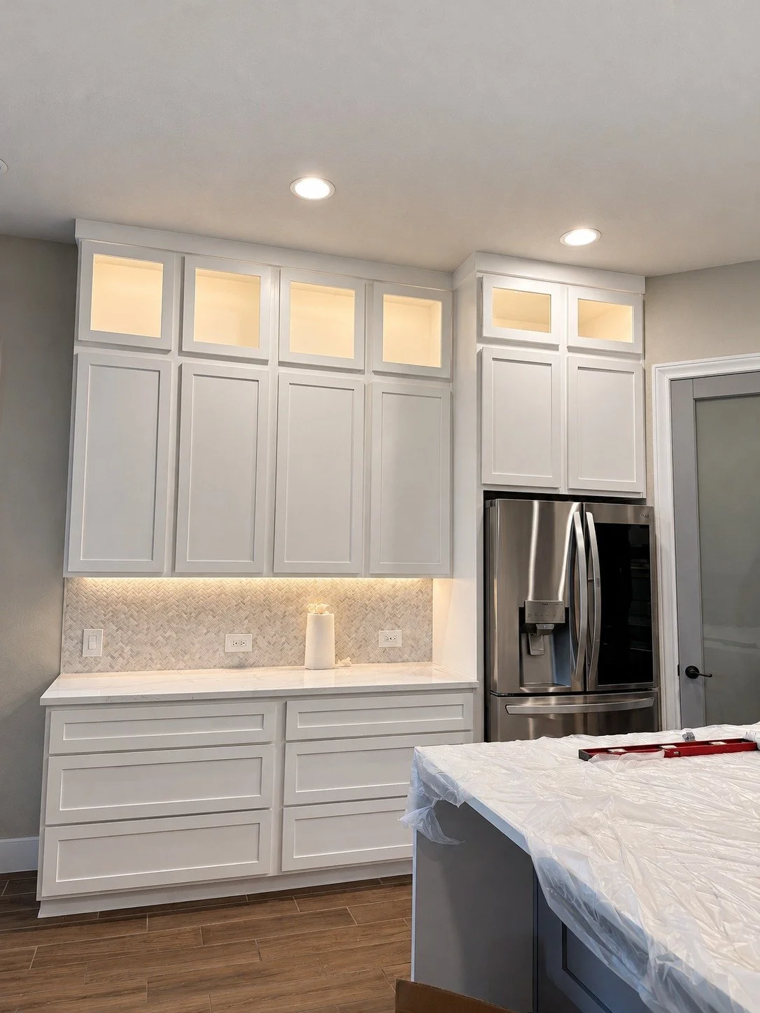Installation — the cabinetry and surfaces coming together.