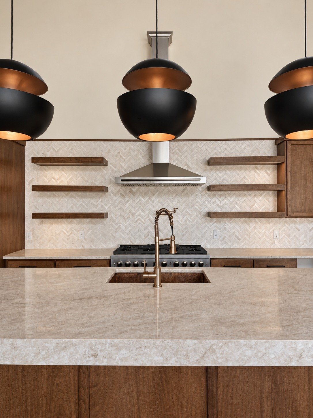 M5 Ranch kitchen — natural wood cabinetry, stone surfaces, and dark pendant lighting.