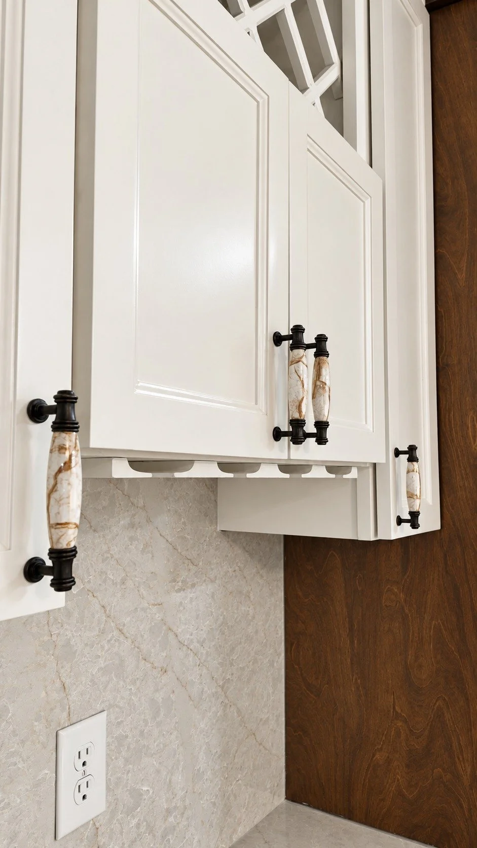 Light cabinet doors with contrasting dark hardware.