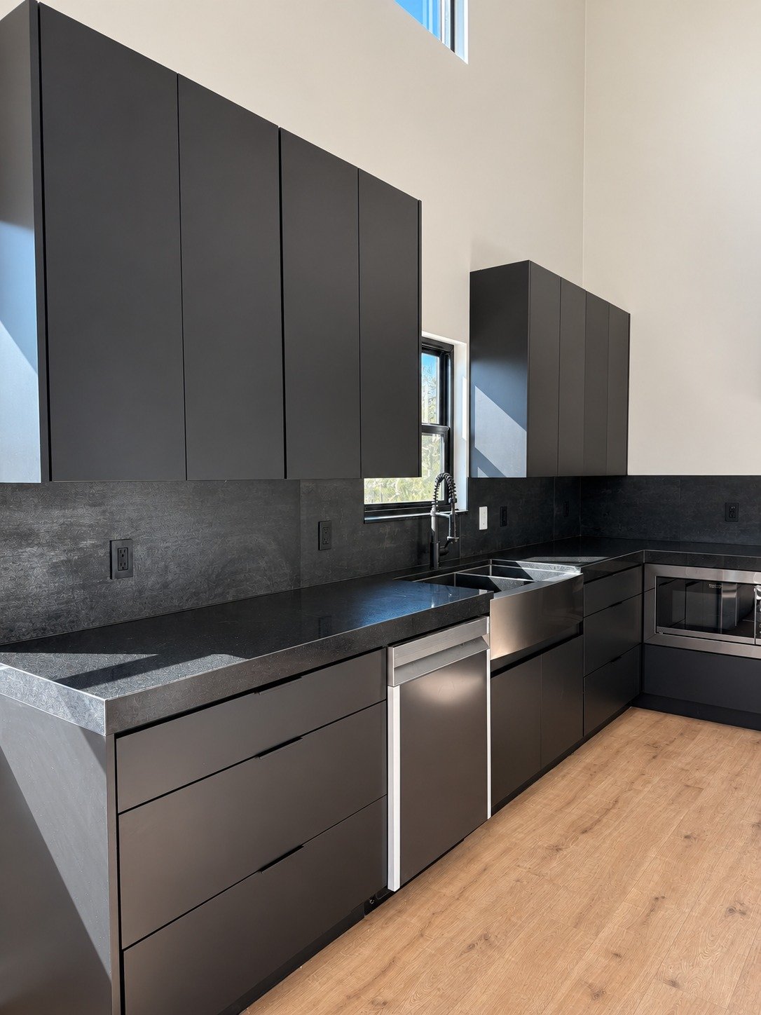 Clean cabinet lines and warm flooring throughout the kitchen.