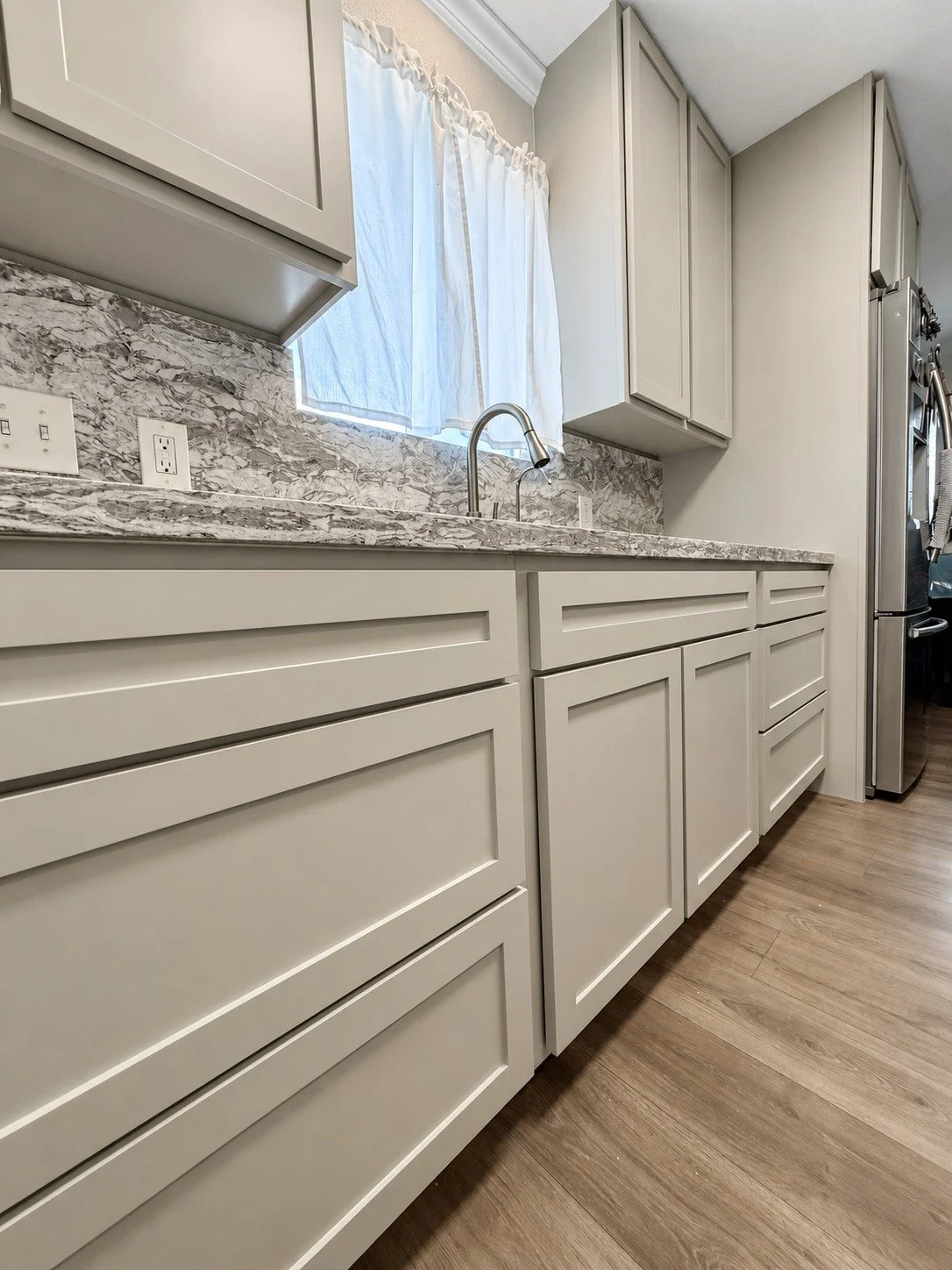 Clean cabinet lines, generous drawers, and a soft neutral palette.