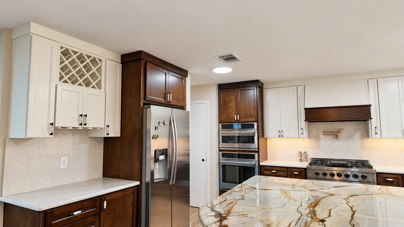A full view of the contrasting cabinetry and stone surfaces.