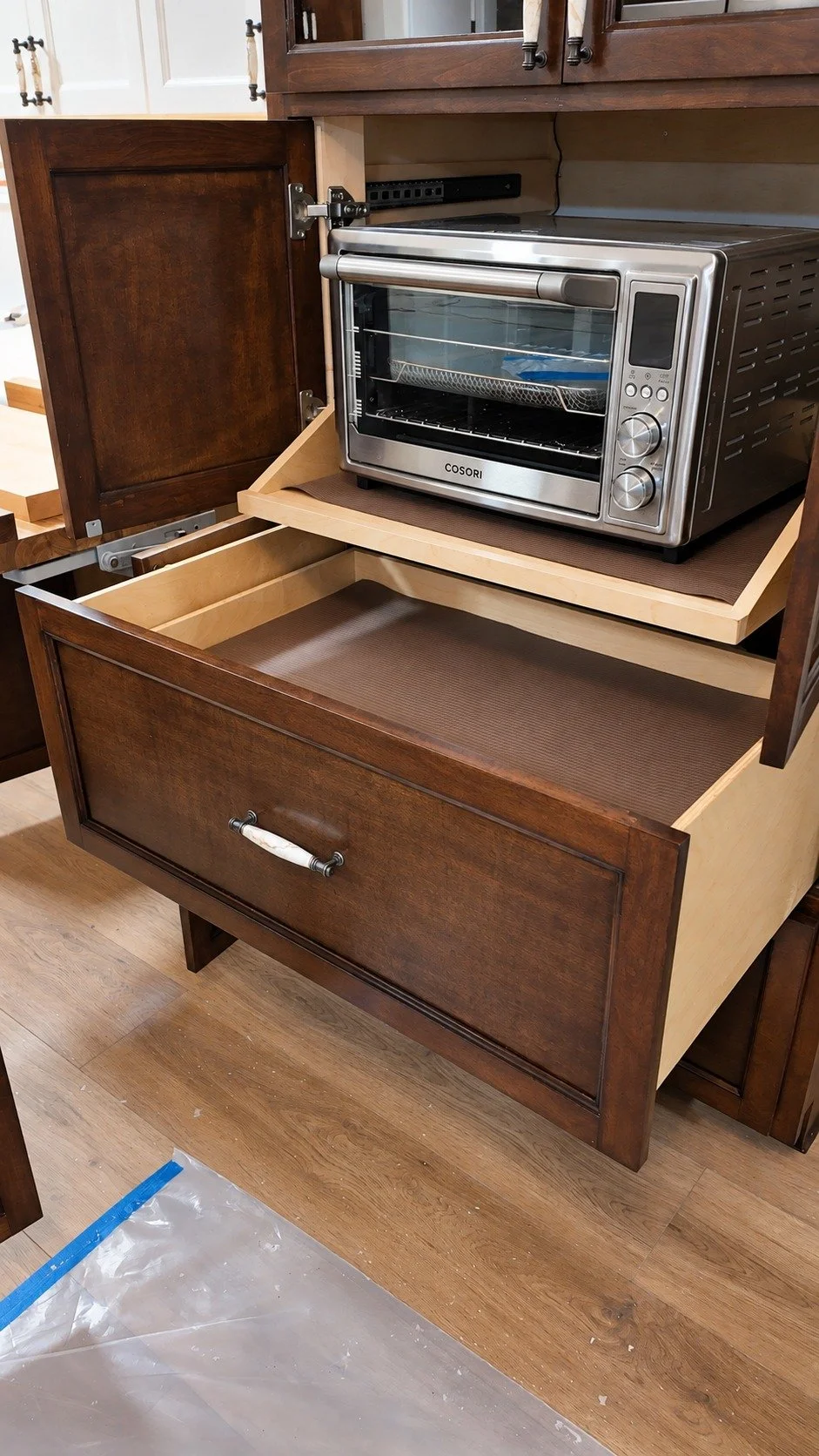A concealed appliance station with a pull-out work surface.