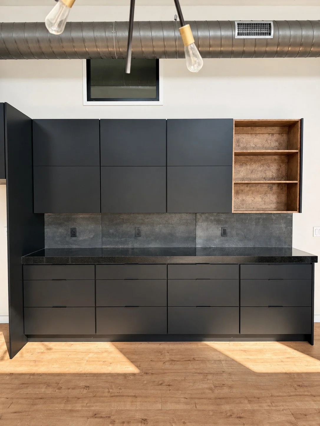 Custom cabinetry and open wood shelving along the adjoining wall.