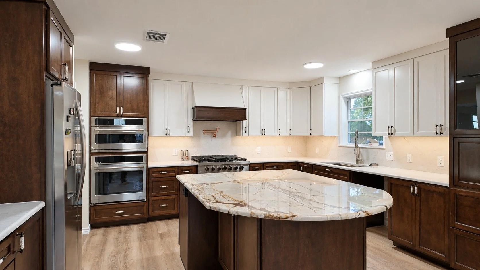 Two Tones — rich wood cabinetry, light upper cabinets, and a generous stone island.