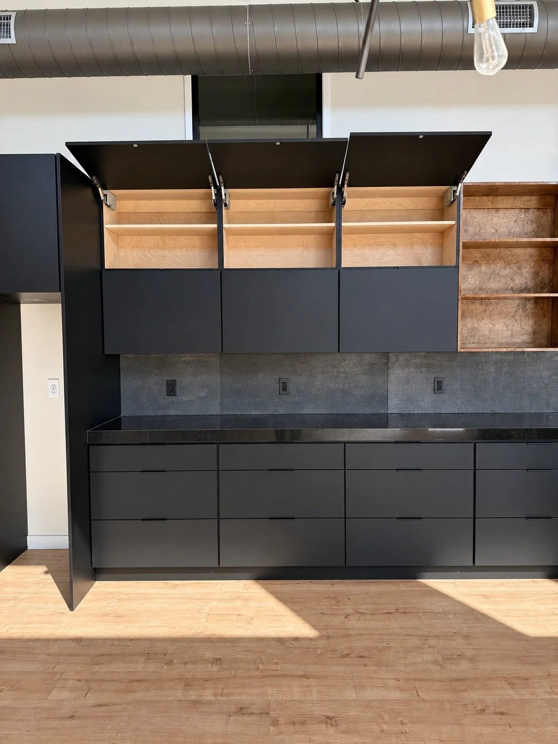 Cabinet detail — the lift-up door system in use.