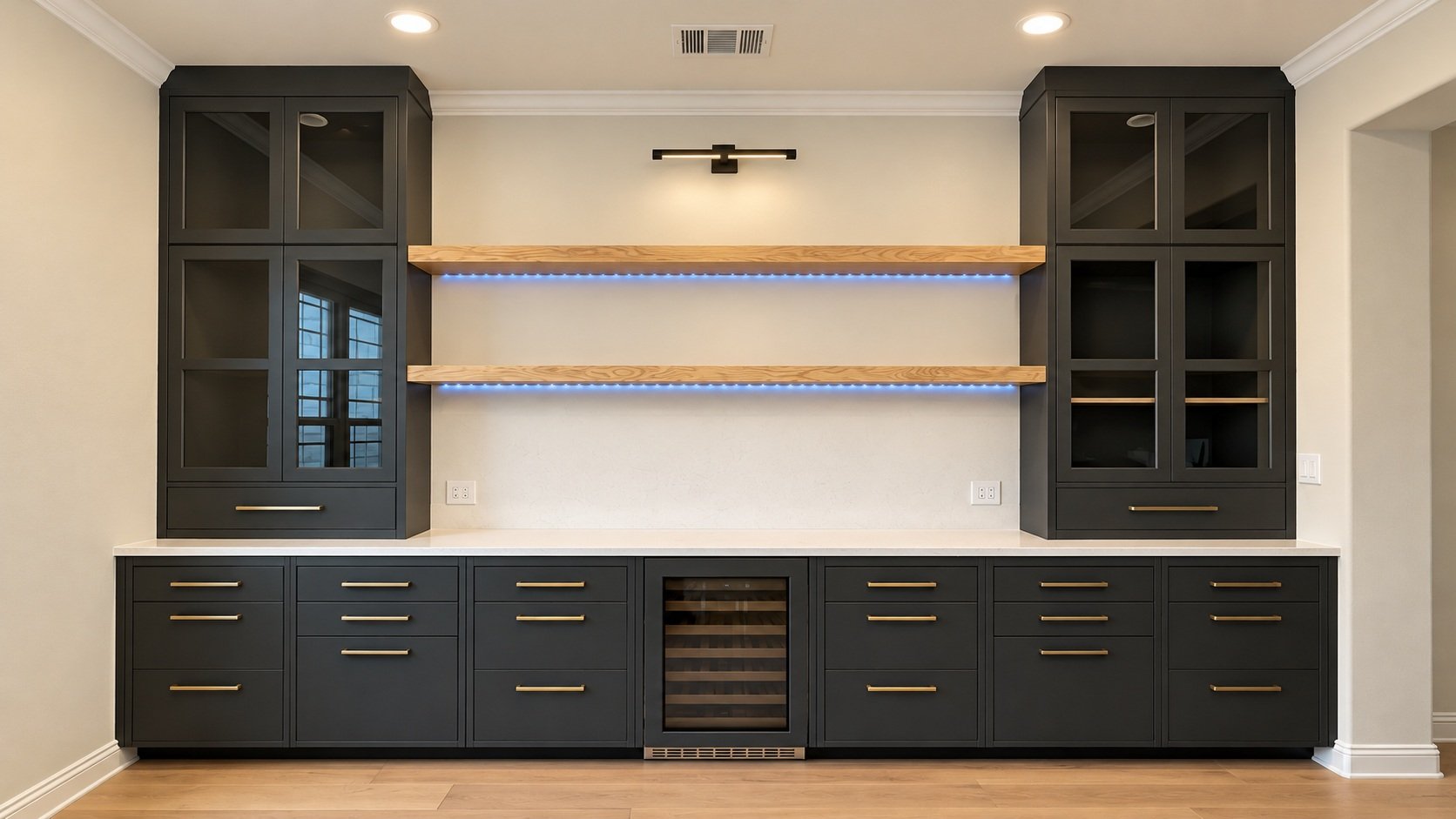 Custom dark bar cabinetry with glass-front doors, wood floating shelves, and a beverage cooler.