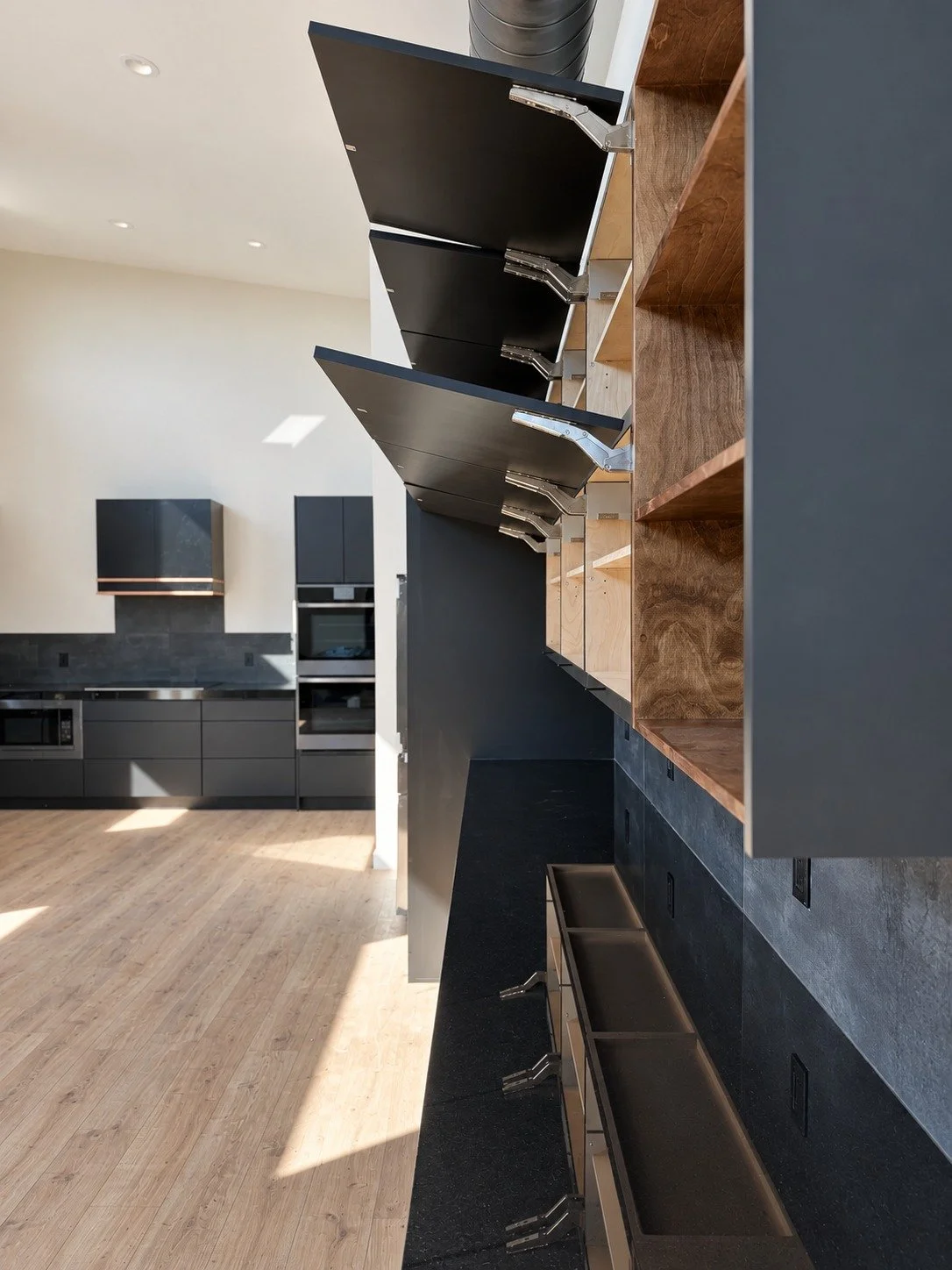 Cabinet detail — lift-up doors reveal accessible upper storage.
