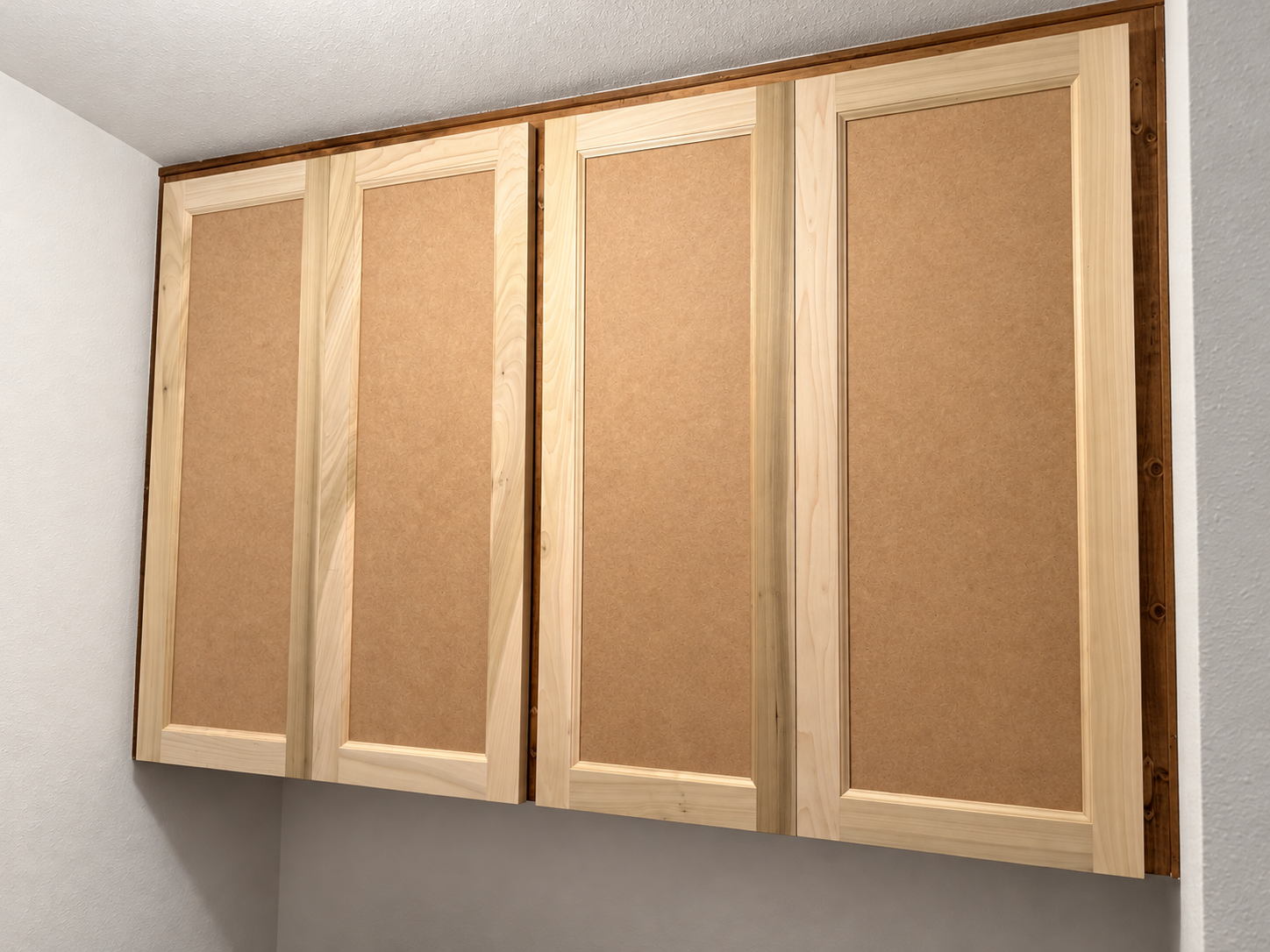 Close-up of new wood-framed cabinet doors before finishing.