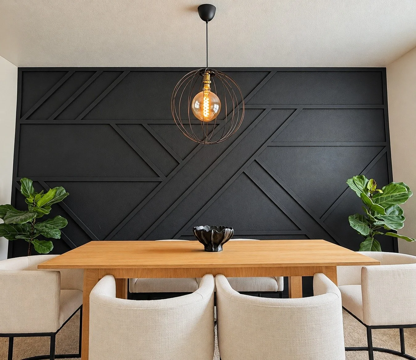 Custom wood dining table with upholstered chairs and a geometric feature wall.