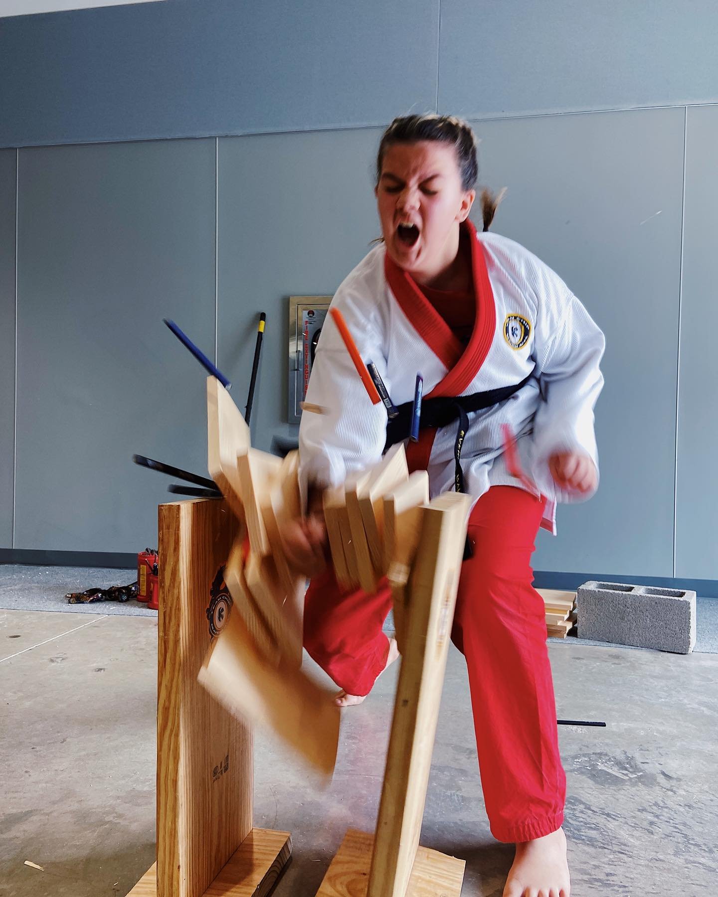 Martial artist breaking wooden boards with a hand strike