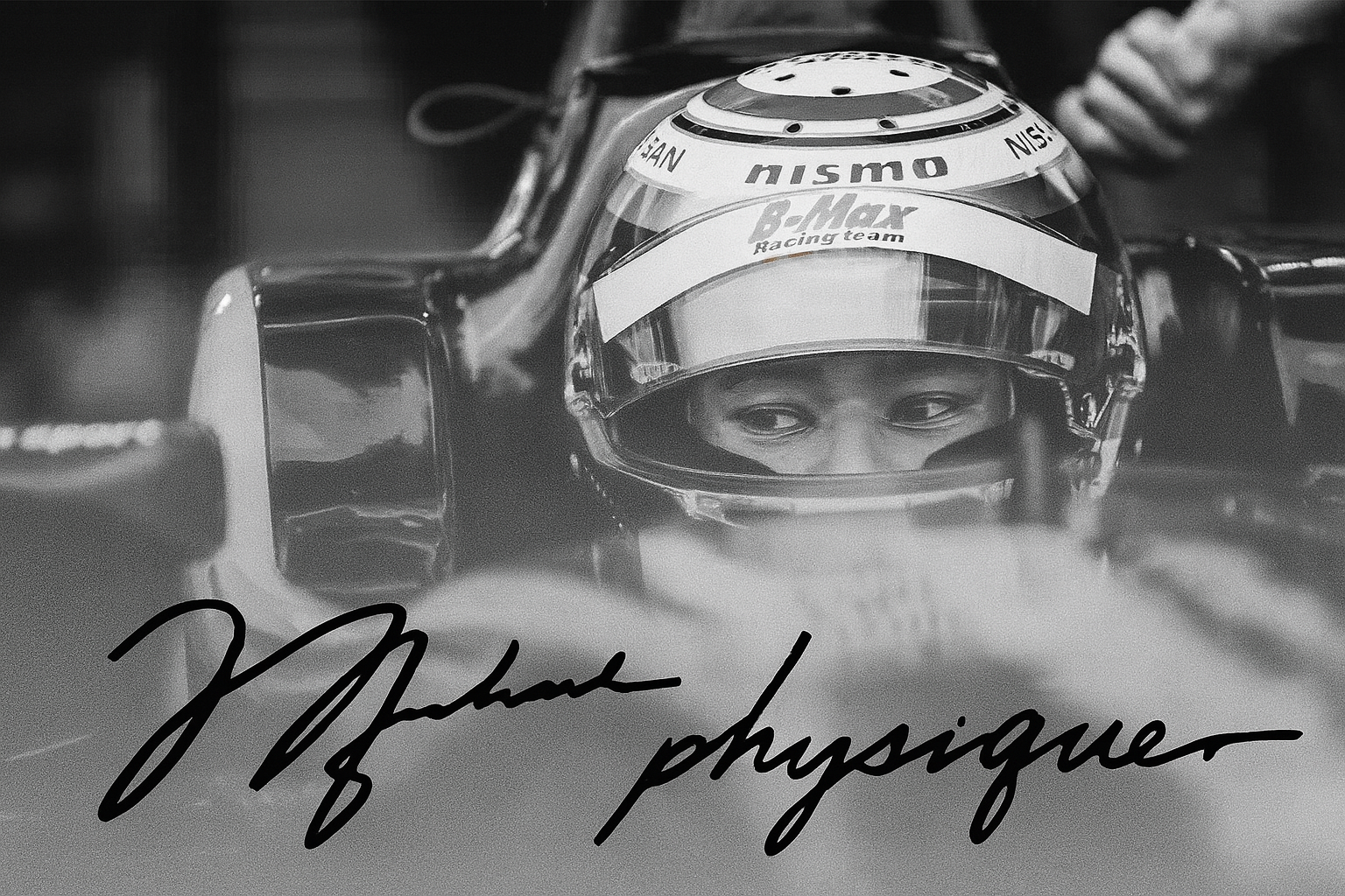 Black and white photograph of race car driver wearing helmet, with the driver's face visible through the visor, leaning forward in the car. Autograph written across the image.
