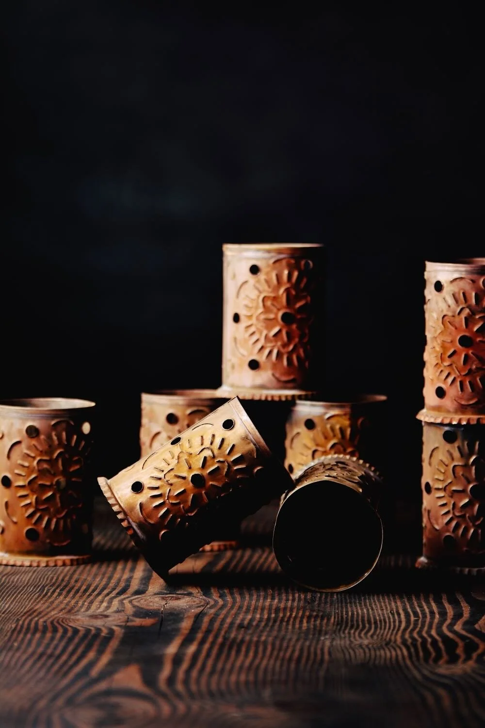 Luminarias de Bronce - Shop handmade bronze luminarias from Mexico. Elegant candle holders with punched designs, perfect for patios, walkways, and ambient lighting.