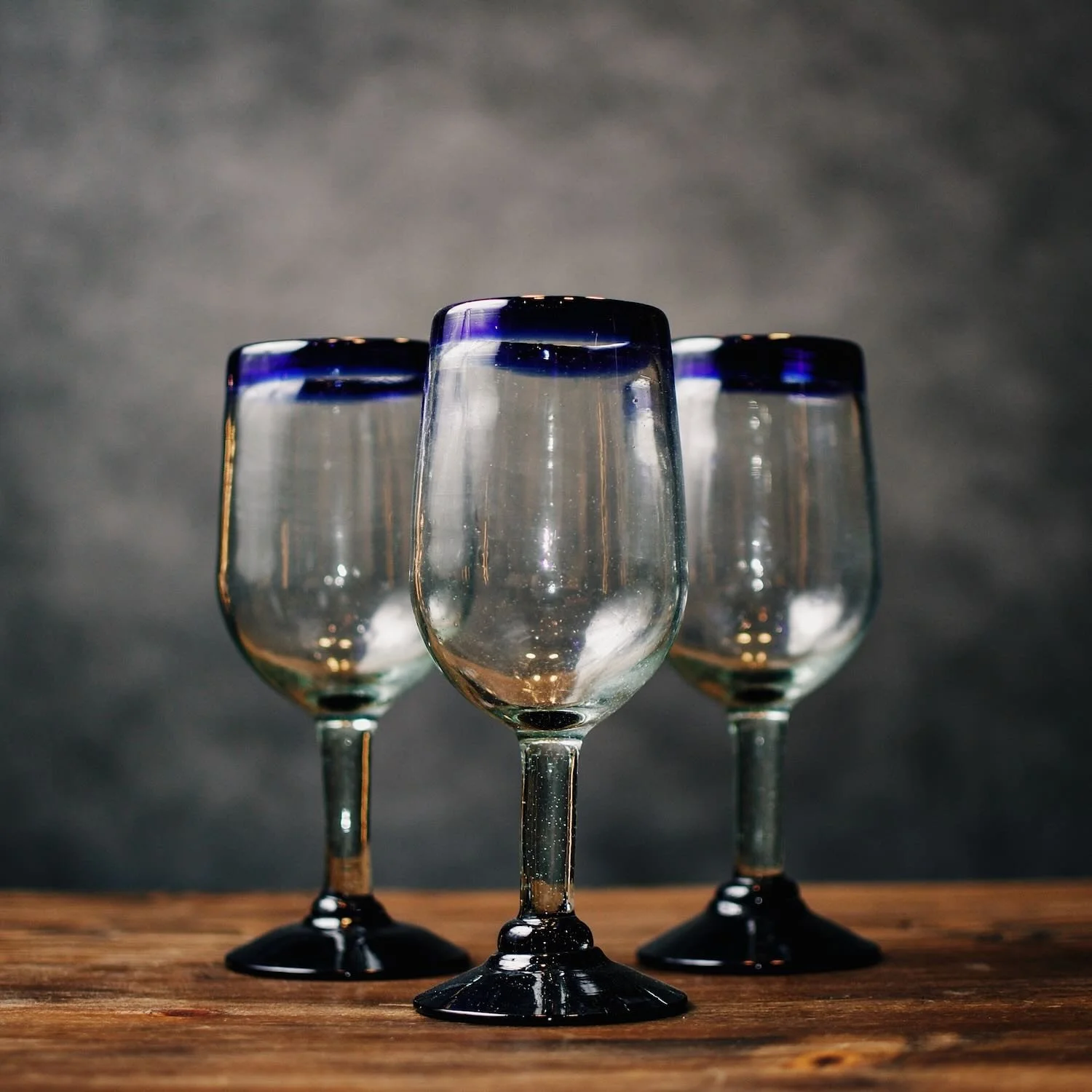 Handmade Mexican Cantina wine glass with traditional cobalt blue rim and handblown artisan glass.