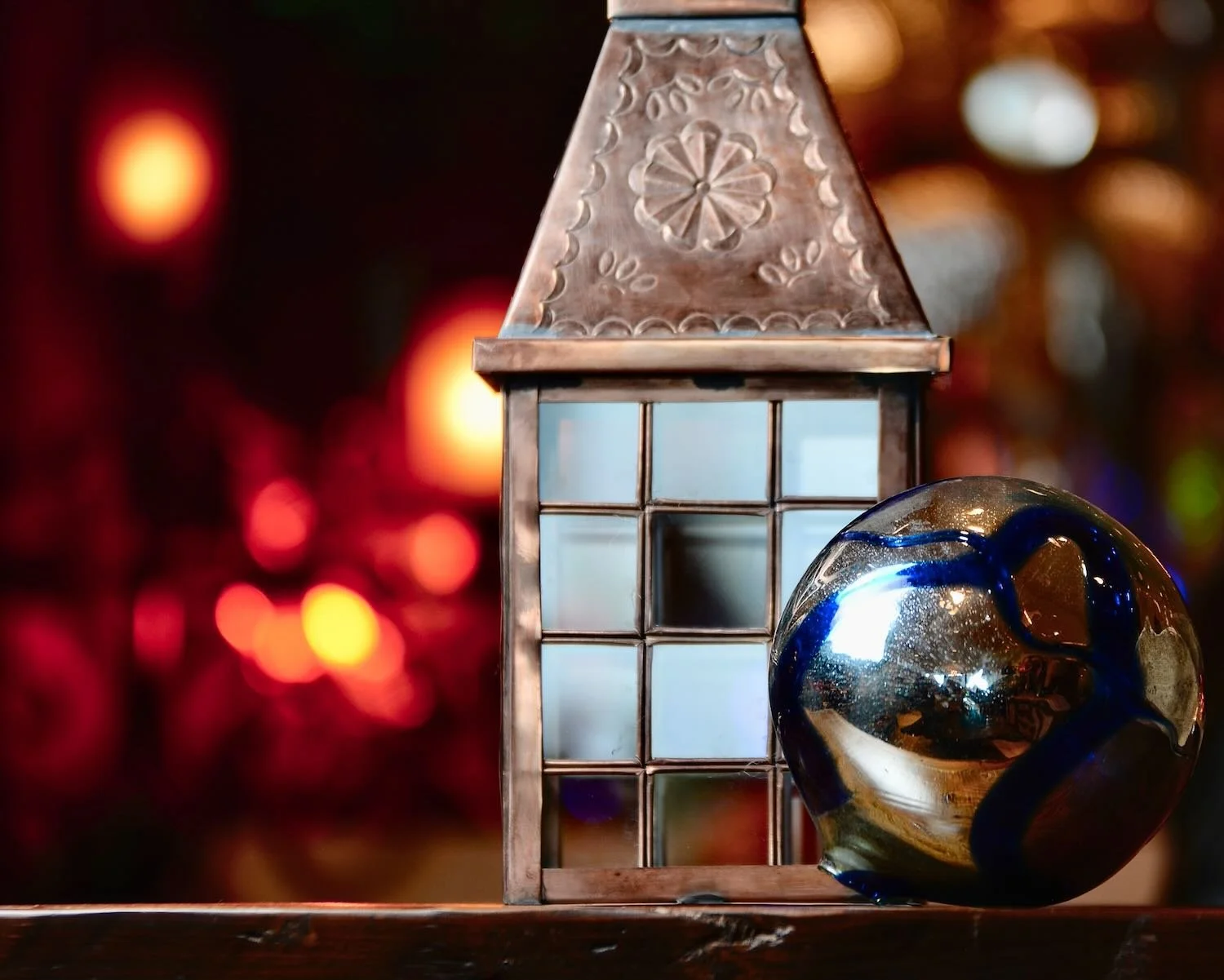 Bronze hand punched lantern and handblown glass ball.