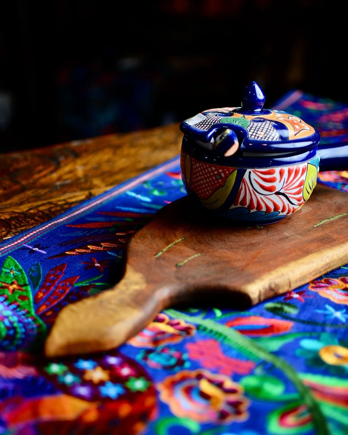Handmade Mexican mesquite wood cutting board with turquoise inlay and natural wood grain.