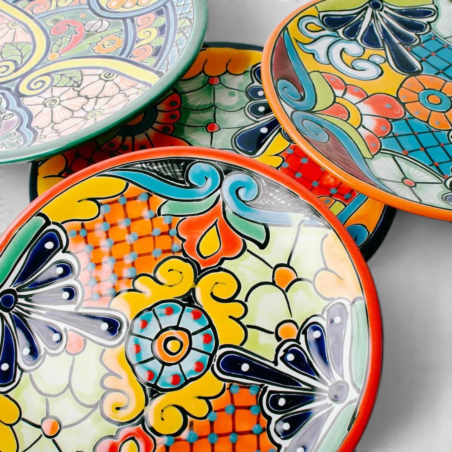 Handmade Mexican Talavera 12-inch dinner plate with colorful hand-painted design and assorted rim colors