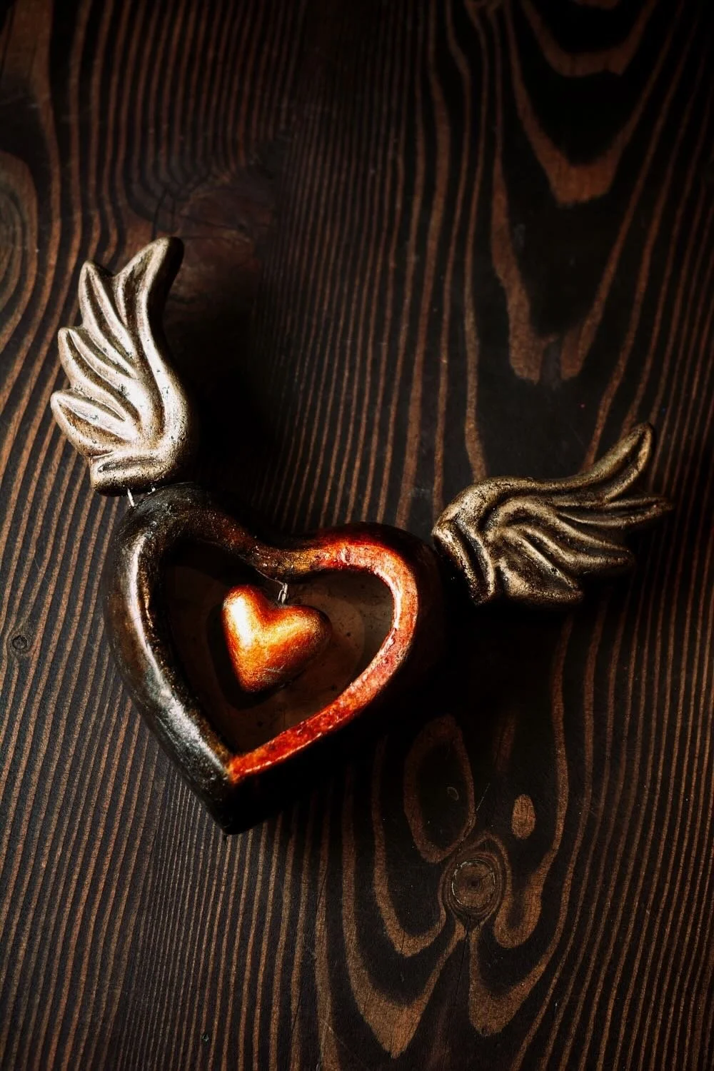 Shop a handmade Sacred Heart sculpture from Mexico. Clay wall decor with wings symbolizing faith, devotion, and artisan craftsmanship.