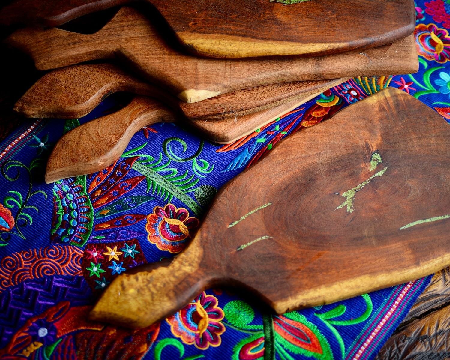 Handmade Mexican mesquite wood cutting board with turquoise inlay and natural wood grain.