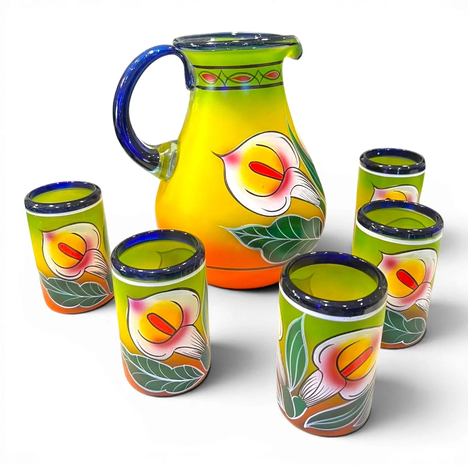 Handblown painted calla lily glass pitcher with five matching tumblers handmade in Mexico featuring blue accents and vibrant floral artwork.