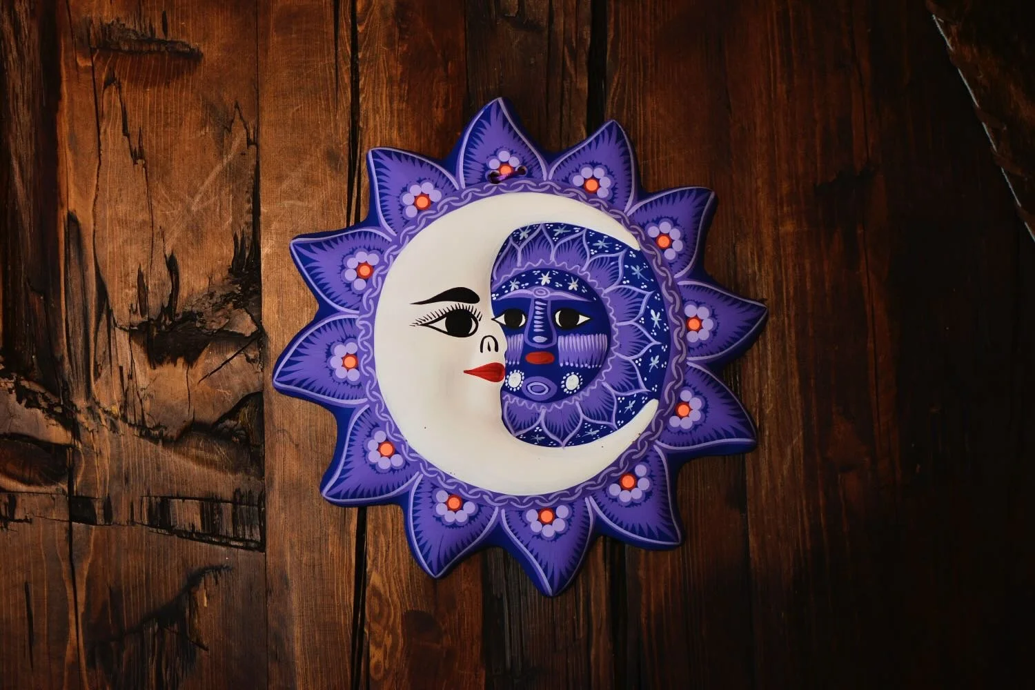 Handmade Arcilla Sol y Luna clay wall art from Oaxaca, Mexico featuring a colorful hand-painted sun and moon design.
