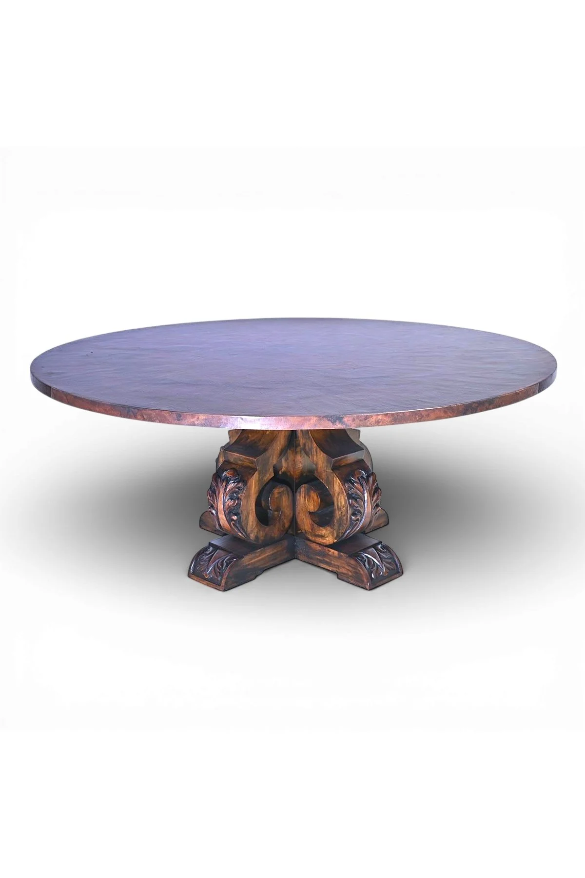 Shop a handmade round copper dining table from Mexico. Rustic luxury furniture with carved wood base and copper top for elegant dining spaces.