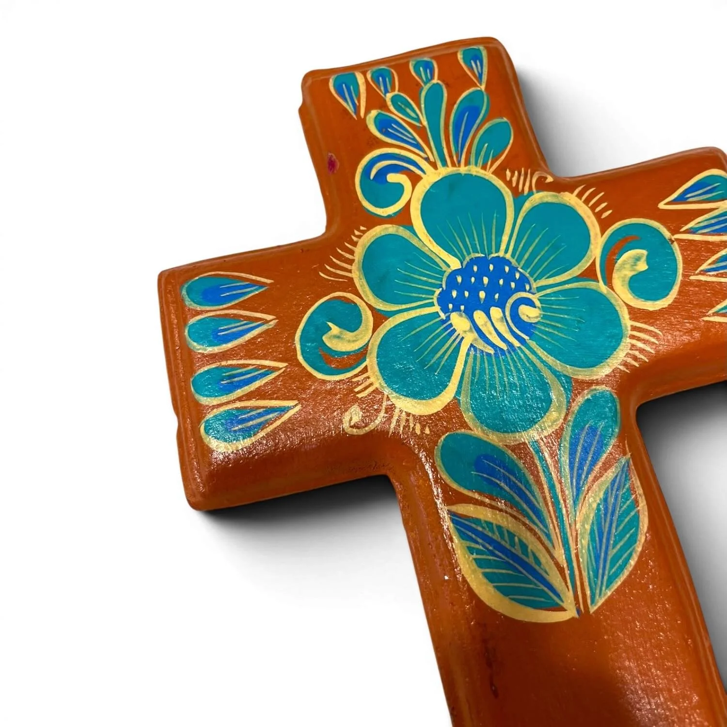 Handmade clay painted cross from Mexico with colorful terracotta and turquoise floral design.