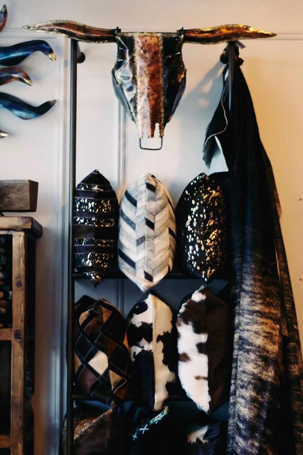 Cowhide and tooled leather pillows, copper cowskull and cowhides.