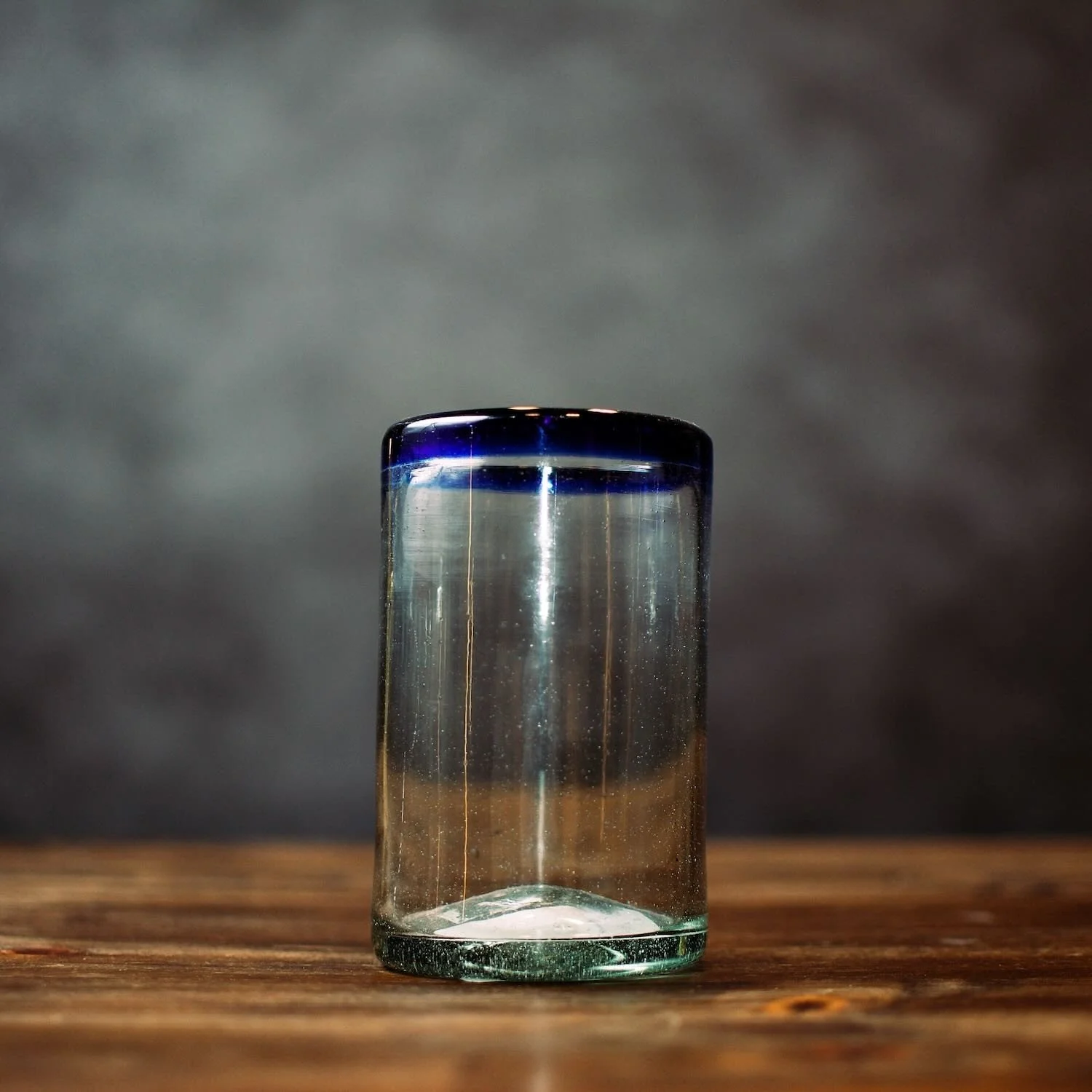 Handmade Mexican Cantina tall glass with traditional cobalt blue rim and handblown artisan craftsmanship.