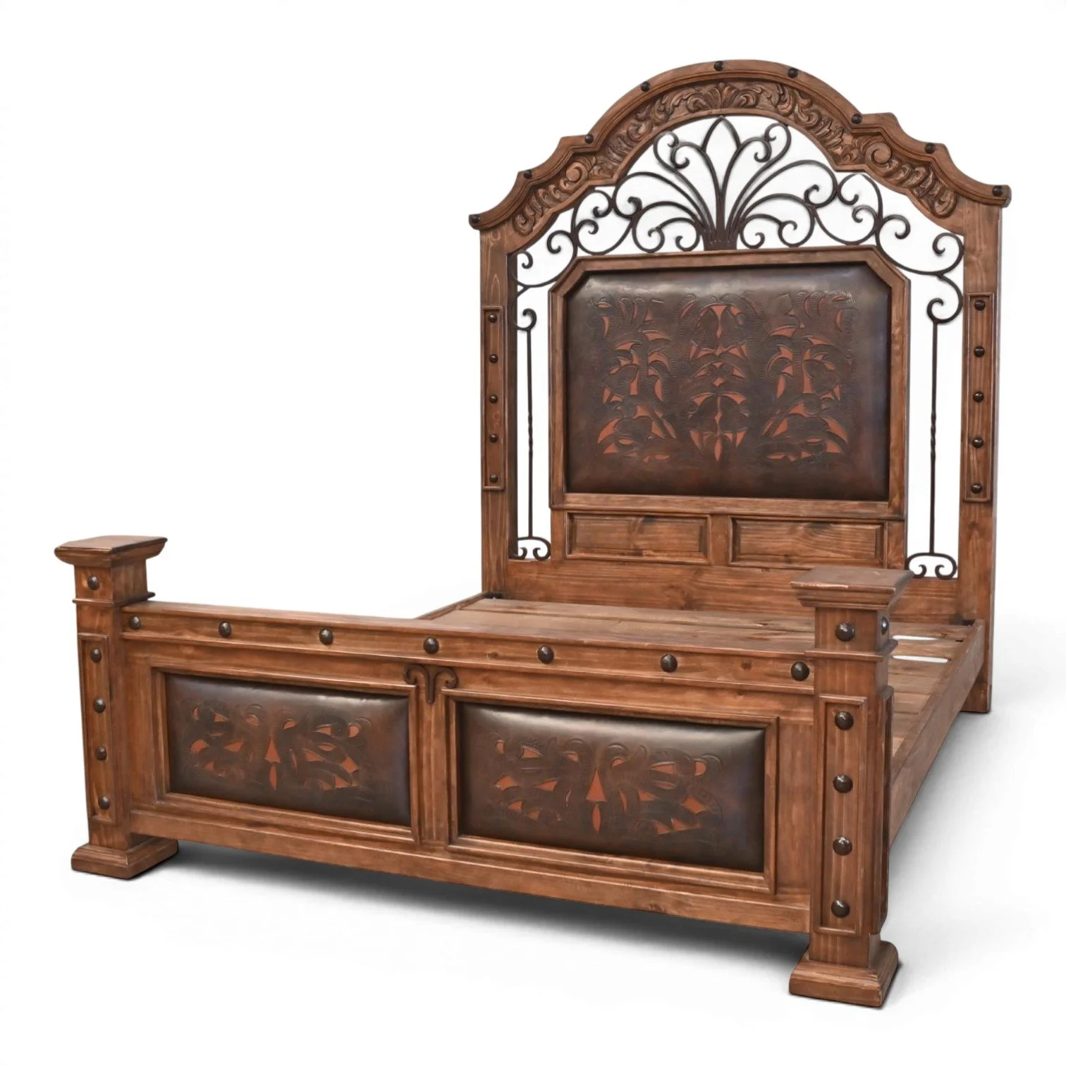 Handmade Hacienda Hierro tooled leather bed with arched headboard, decorative ironwork, hand-carved wood, and rustic clavos accents.