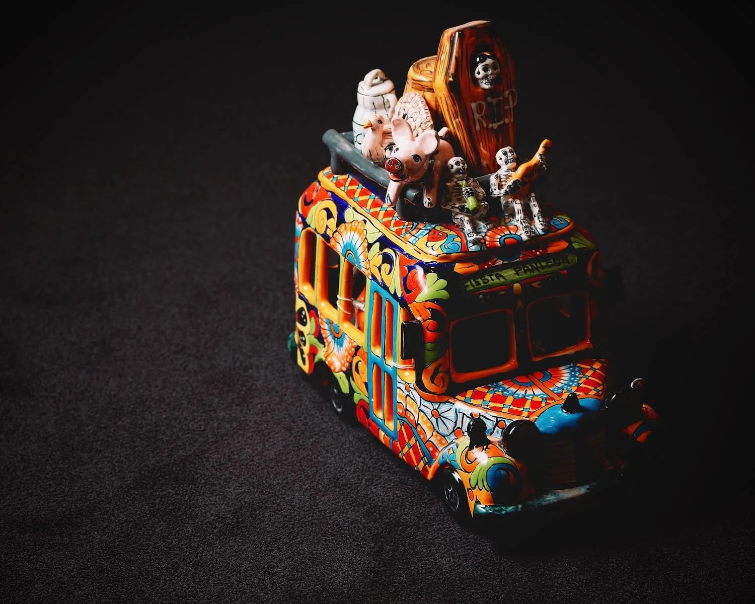 Handmade Mexican Talavera bus with farm animals and Day of the Dead figures.