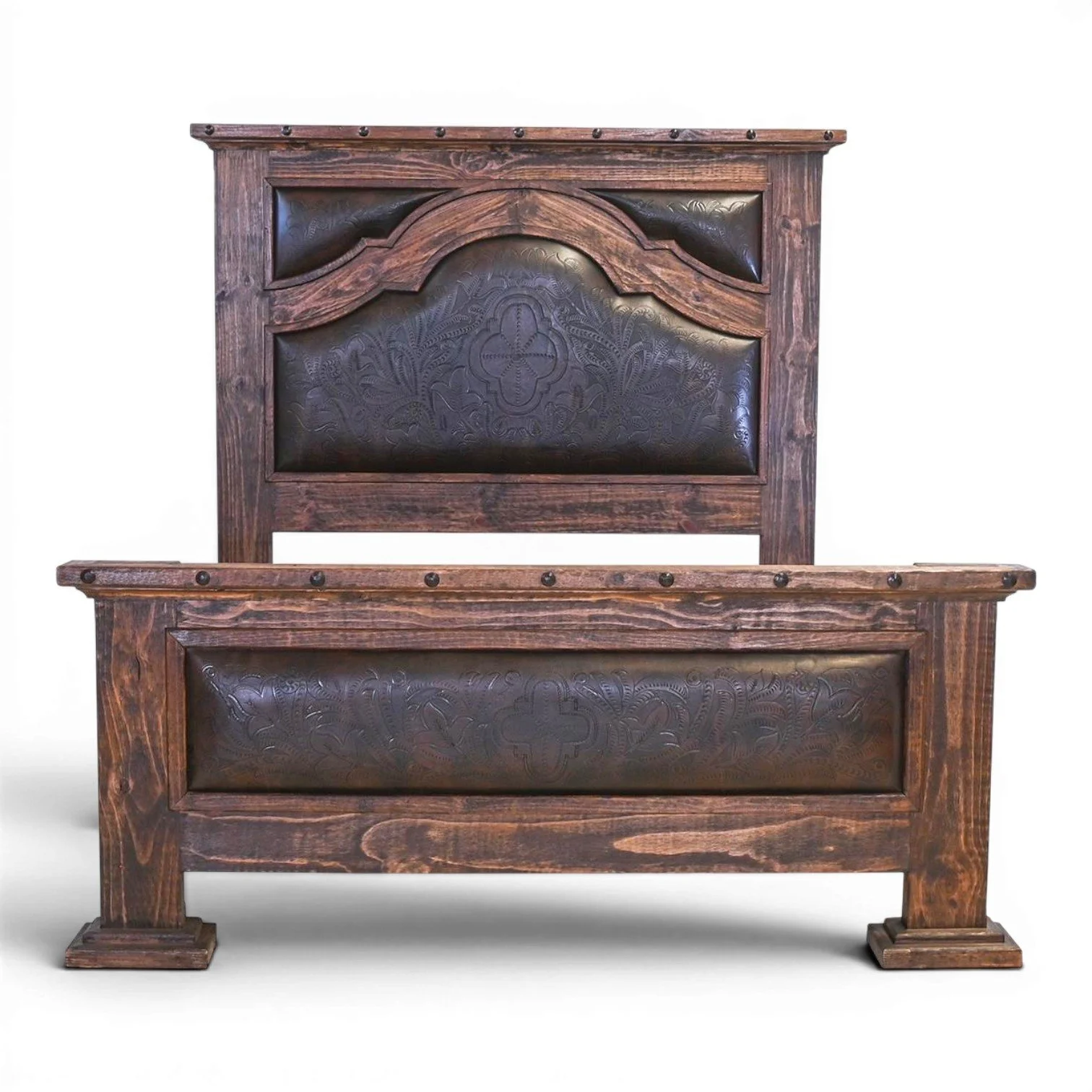 Handmade Tucson tooled leather bed with solid wood frame, carved stain finish, and iron clavos Western design crafted in Mexico.