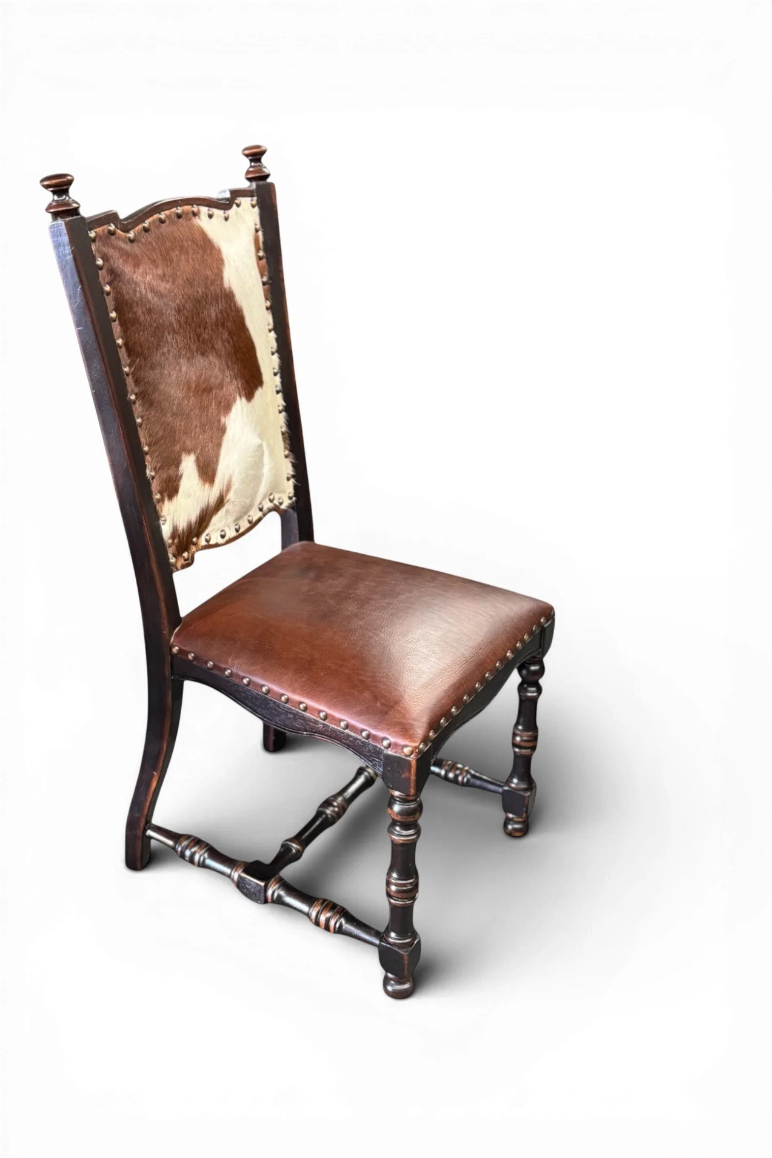 Shop a handmade leather and cowhide dining chair from Peru. Rustic wood frame with nailhead trim and unique hide backrest for stylish seating.