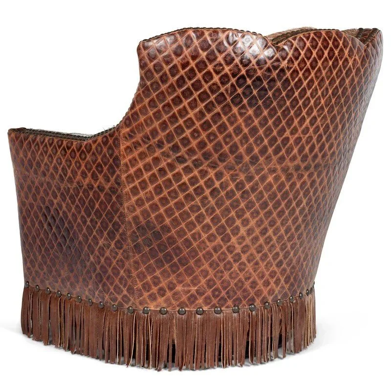 The Arvada Cowhide Fringe Swivel Chair features premium top-grain leather, cowhide accents, fringe detailing, and smooth swivel functionality for refined Western comfort.