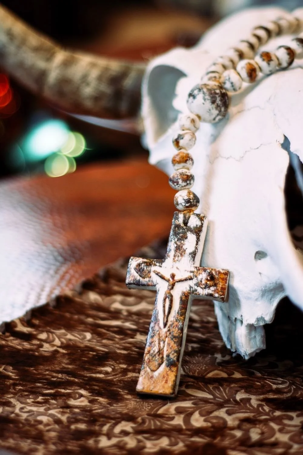 Rosario de Barro. Handcrafted 27" clay rosary from Milagros Rústicos. Features a distressed cream finish. Ideal for home altars or decorative styling.