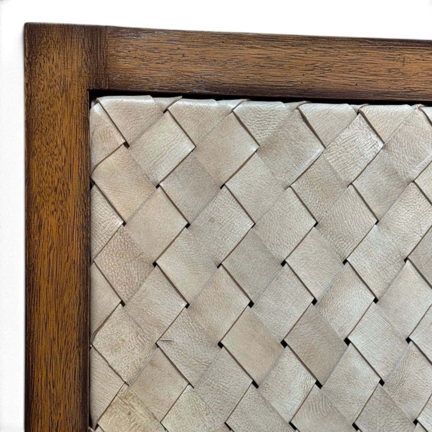Handmade bed with hand-woven leather headboard framed in solid wood