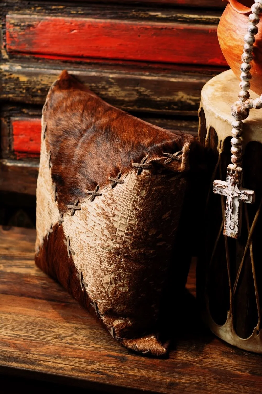 Shop a handmade cowhide and leather pillow from Brazil. Rustic luxury accent pillow with unique patterns for sofas, chairs, and home decor.