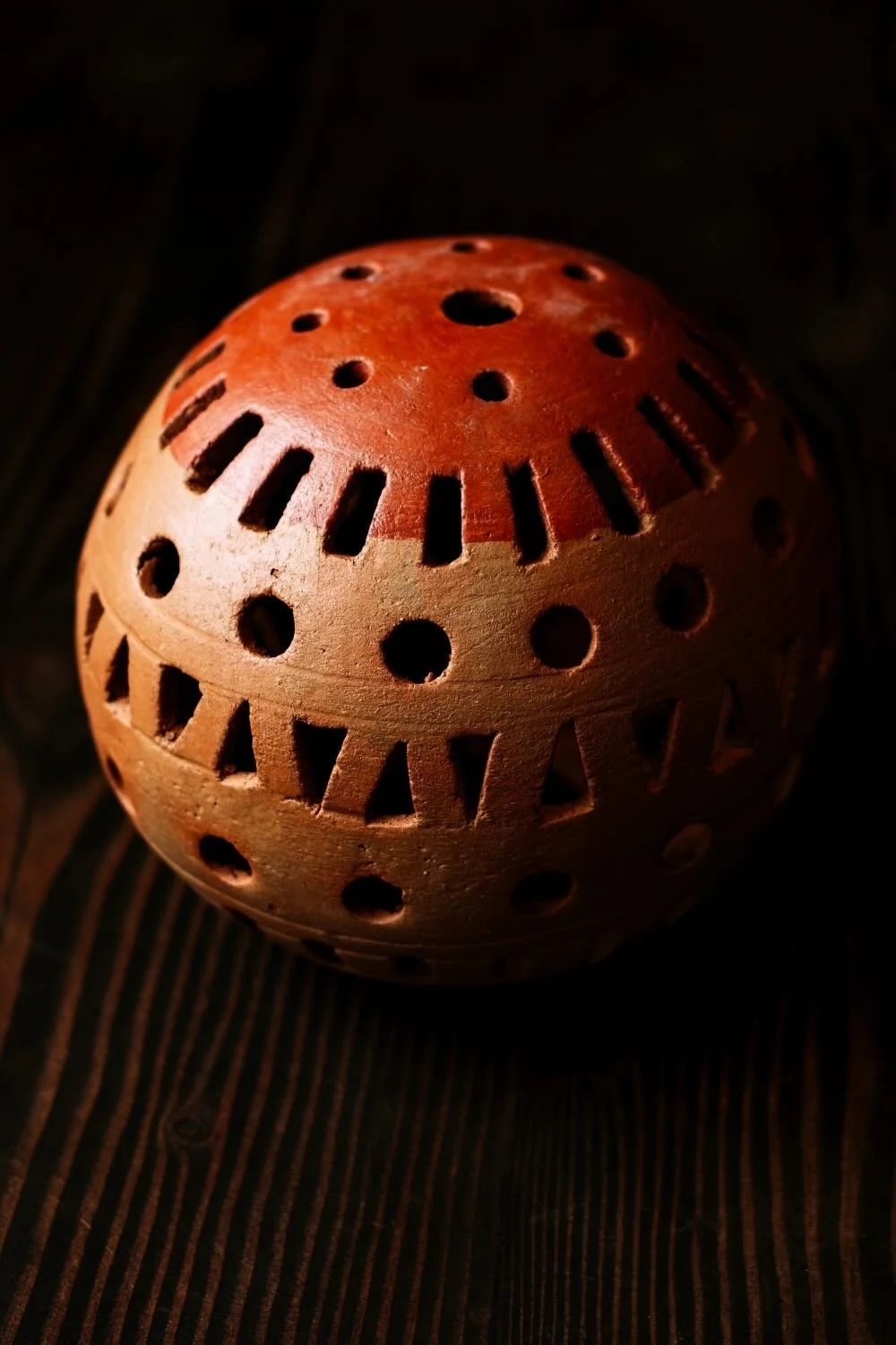 Shop a handmade clay sphere luminaria from Oaxaca, Mexico. Unique cutout design creates warm ambient candlelight for rustic decor.