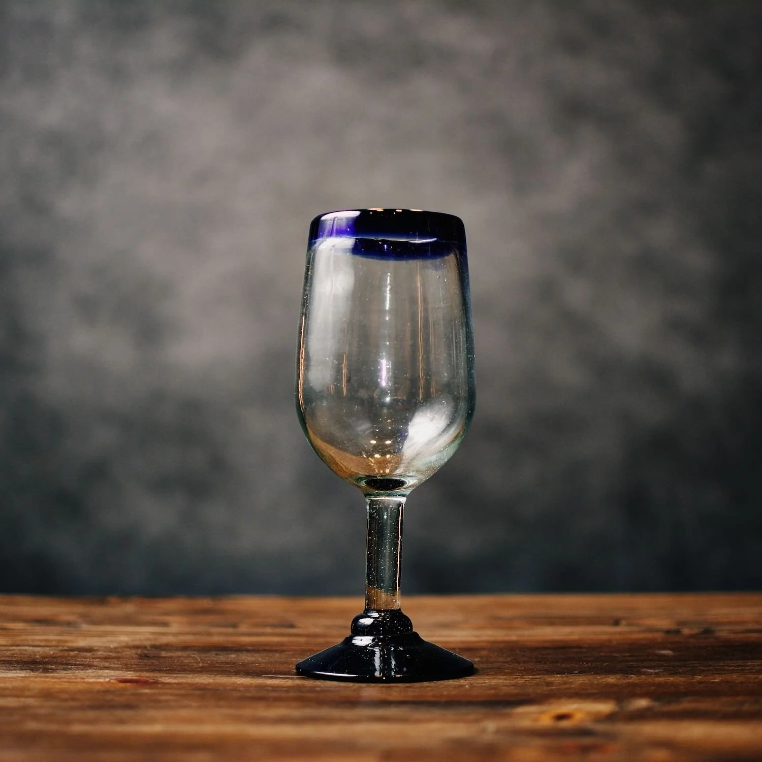Handmade Mexican Cantina wine glass with traditional cobalt blue rim and handblown artisan glass.