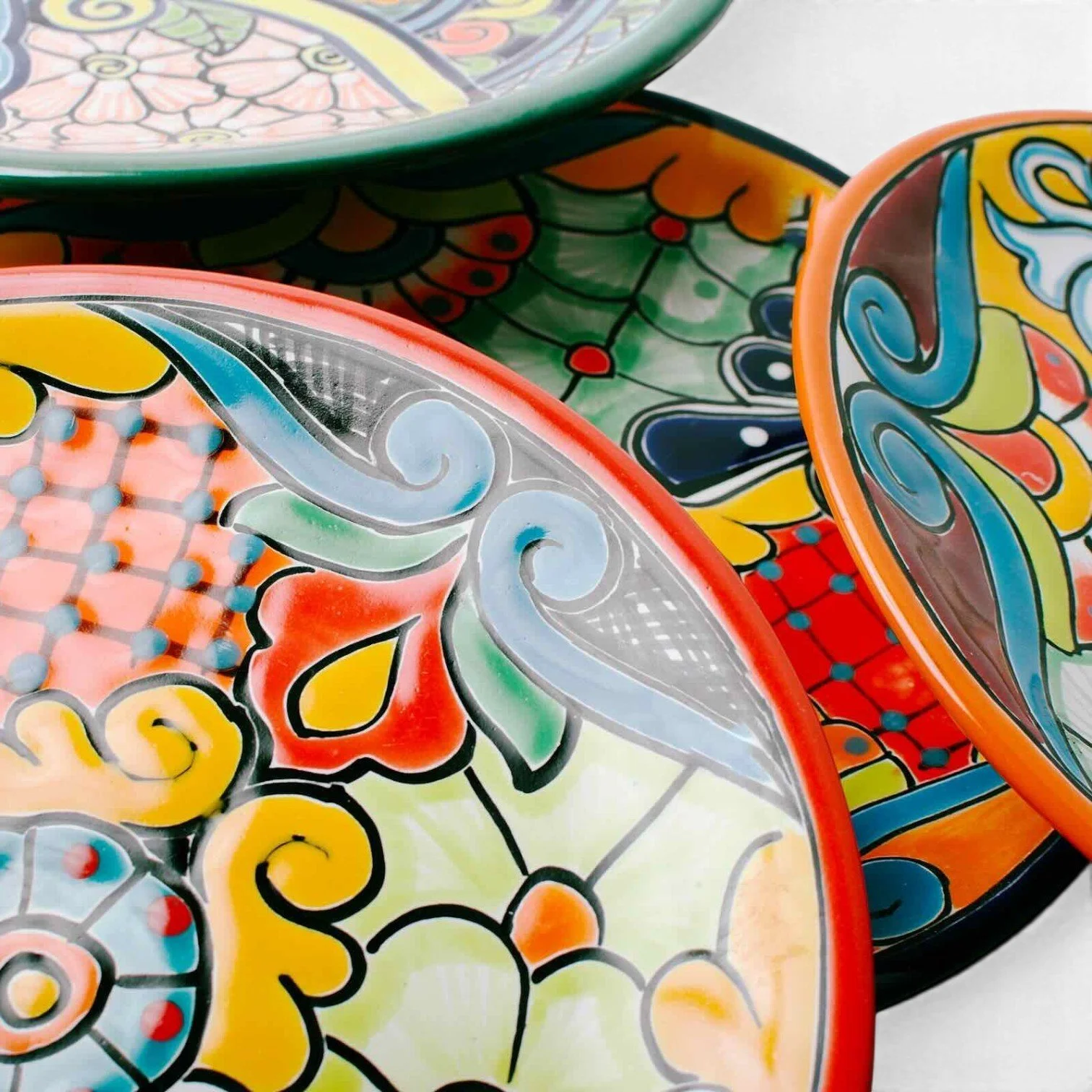 Handmade Mexican Talavera 12-inch dinner plate with colorful hand-painted design and assorted rim colors