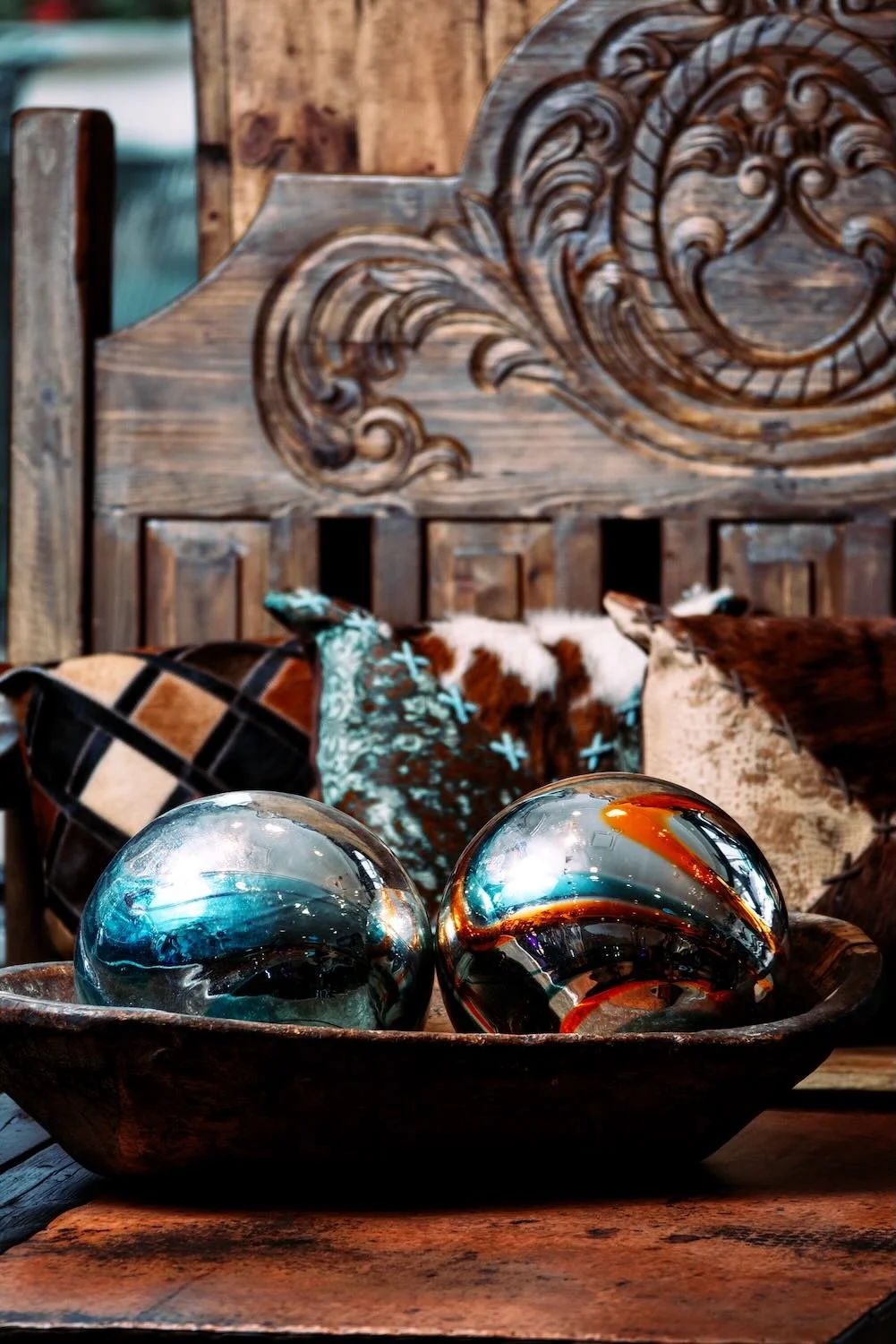 Handblown glass balls, hand pounded copper coffee table and hand carved bench from Mexico.