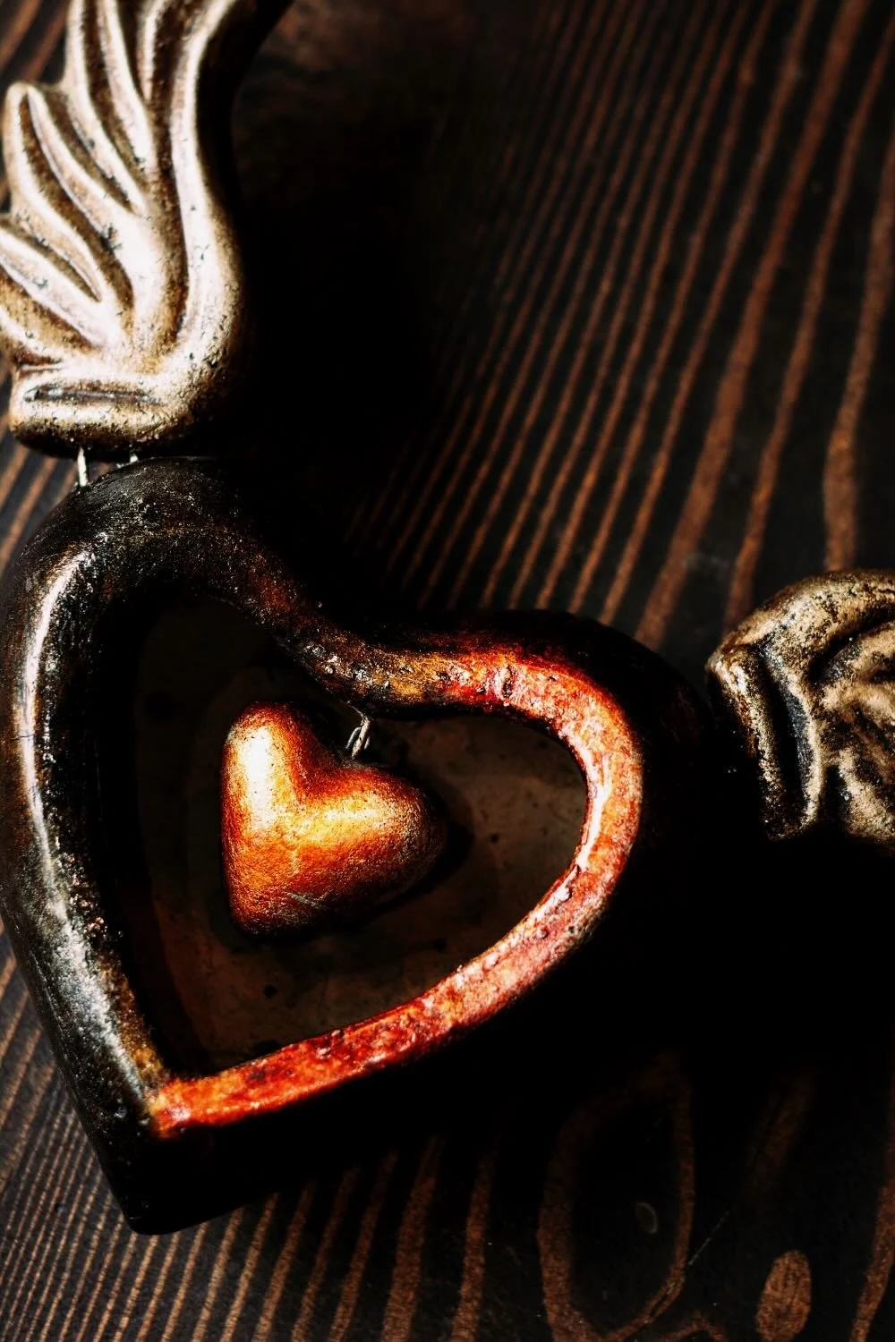 Shop a handmade Sacred Heart sculpture from Mexico. Clay wall decor with wings symbolizing faith, devotion, and artisan craftsmanship.