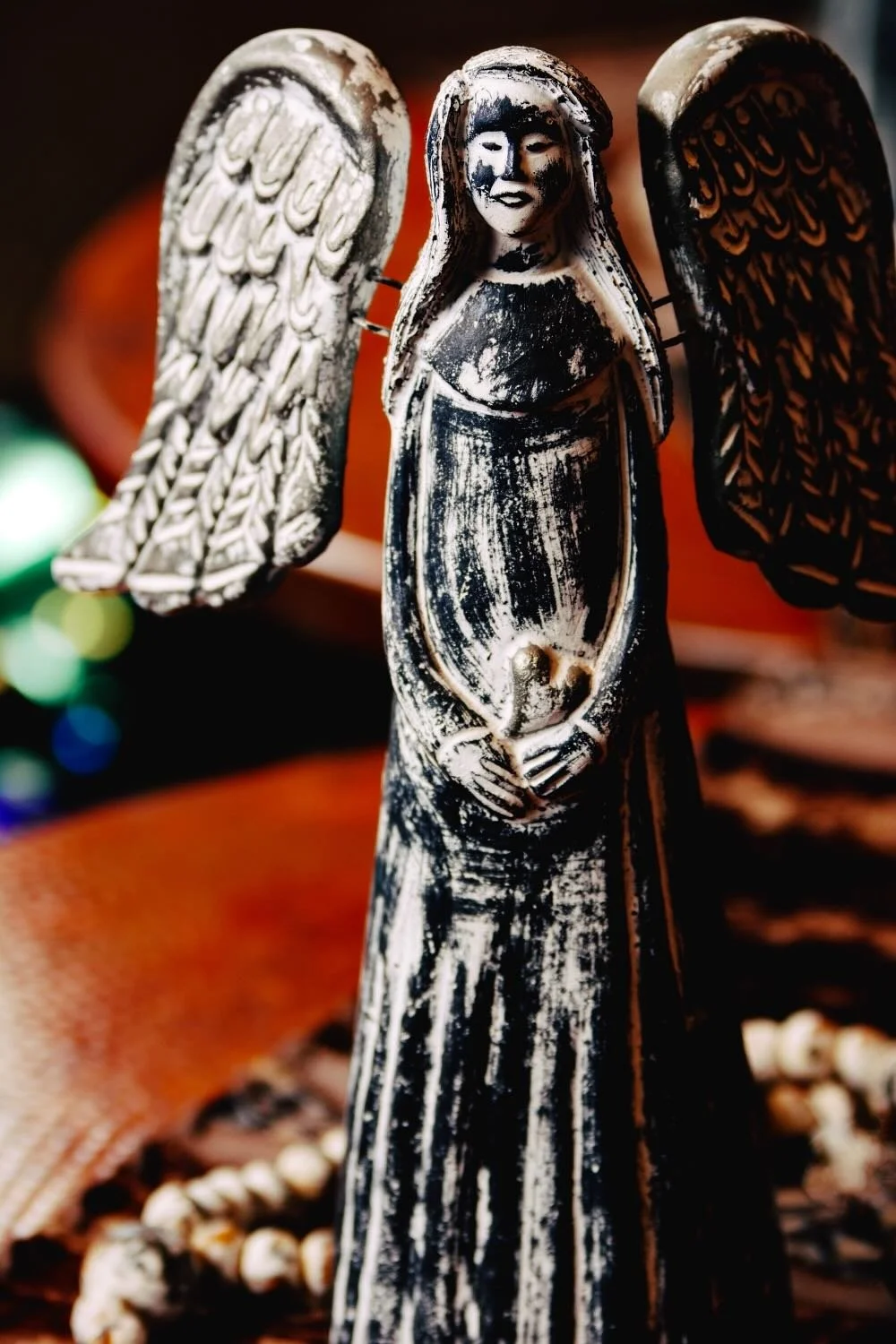 Ángel y Corazón. Hand-sculpted Mexican clay angel holding a heart. Features a distressed white and silver finish.