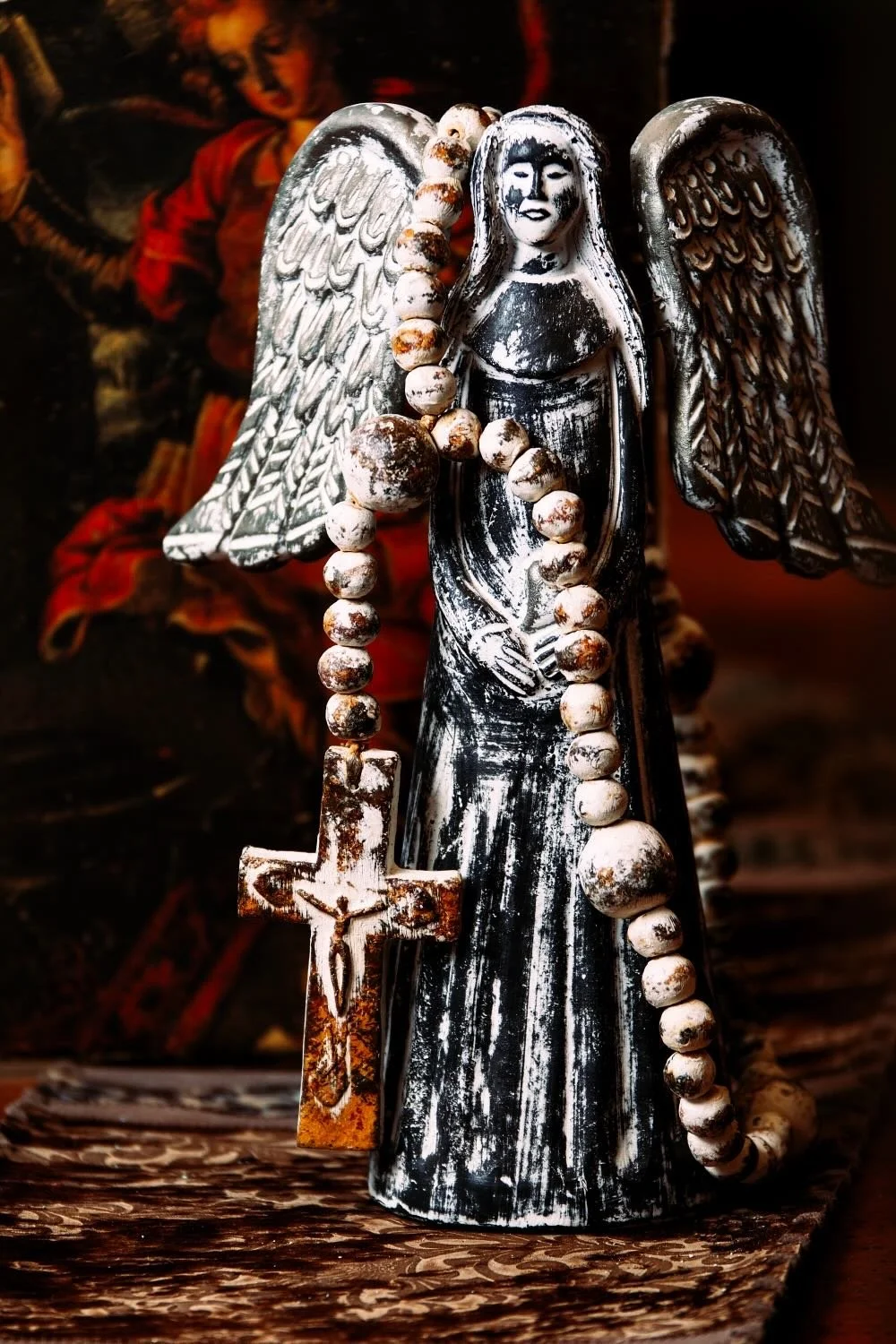 Ángel y Corazón. Hand-sculpted Mexican clay angel holding a heart. Features a distressed white and silver finish.